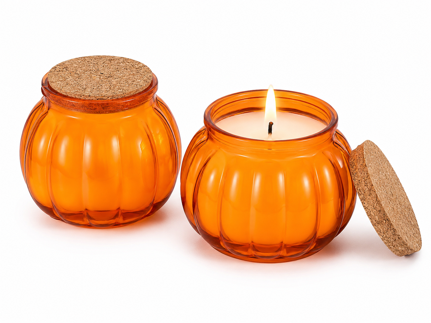 An orange pumpkin-shaped glass candle jar with a cork lid, shown both closed and open with a lit candle on a white background.