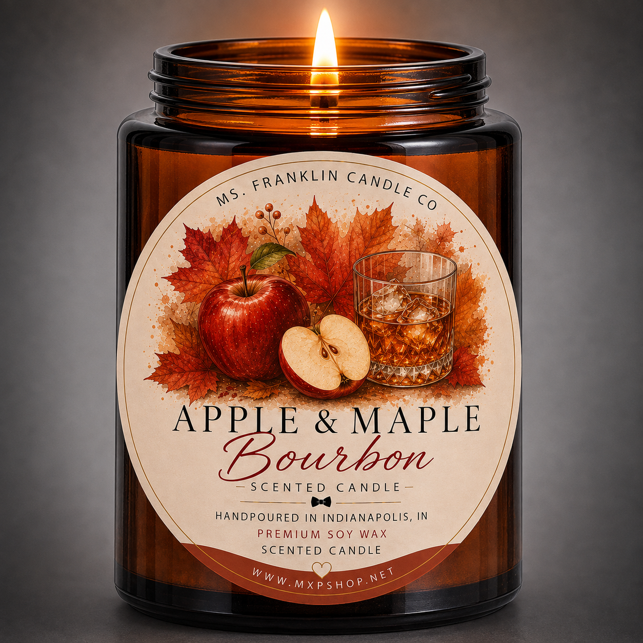 A lit amber glass jar candle with a cream label reading 'Apple & Maple Bourbon' and 'MS. FRANKLIN CANDLE CO.
