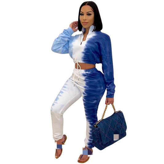 Woman wearing a blue and white tie-dye outfit with a matching bag on a white background