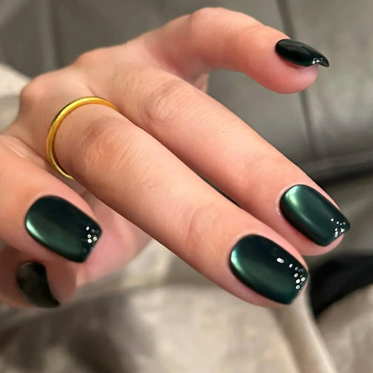 Hand with dark green nail polish on a neutral background