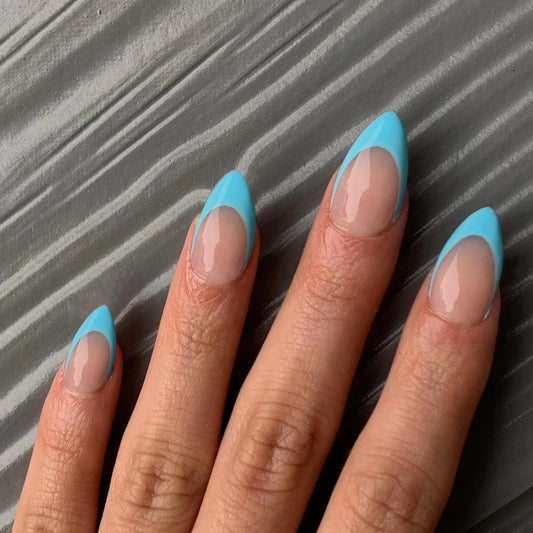 Close-up of a hand with blue nail polish on a textured gray background