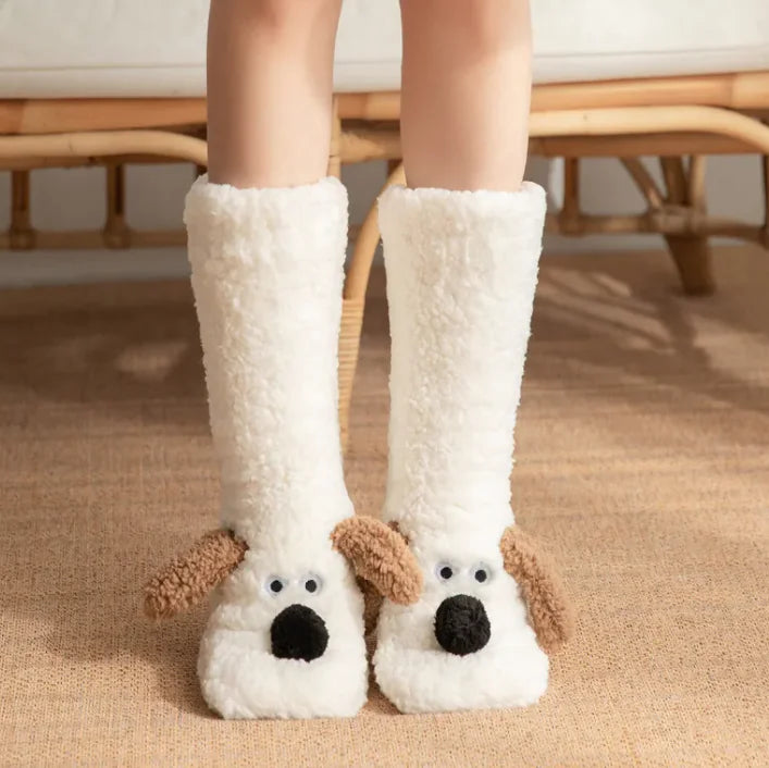 White dog-themed slippers worn by a person on a carpeted floor.