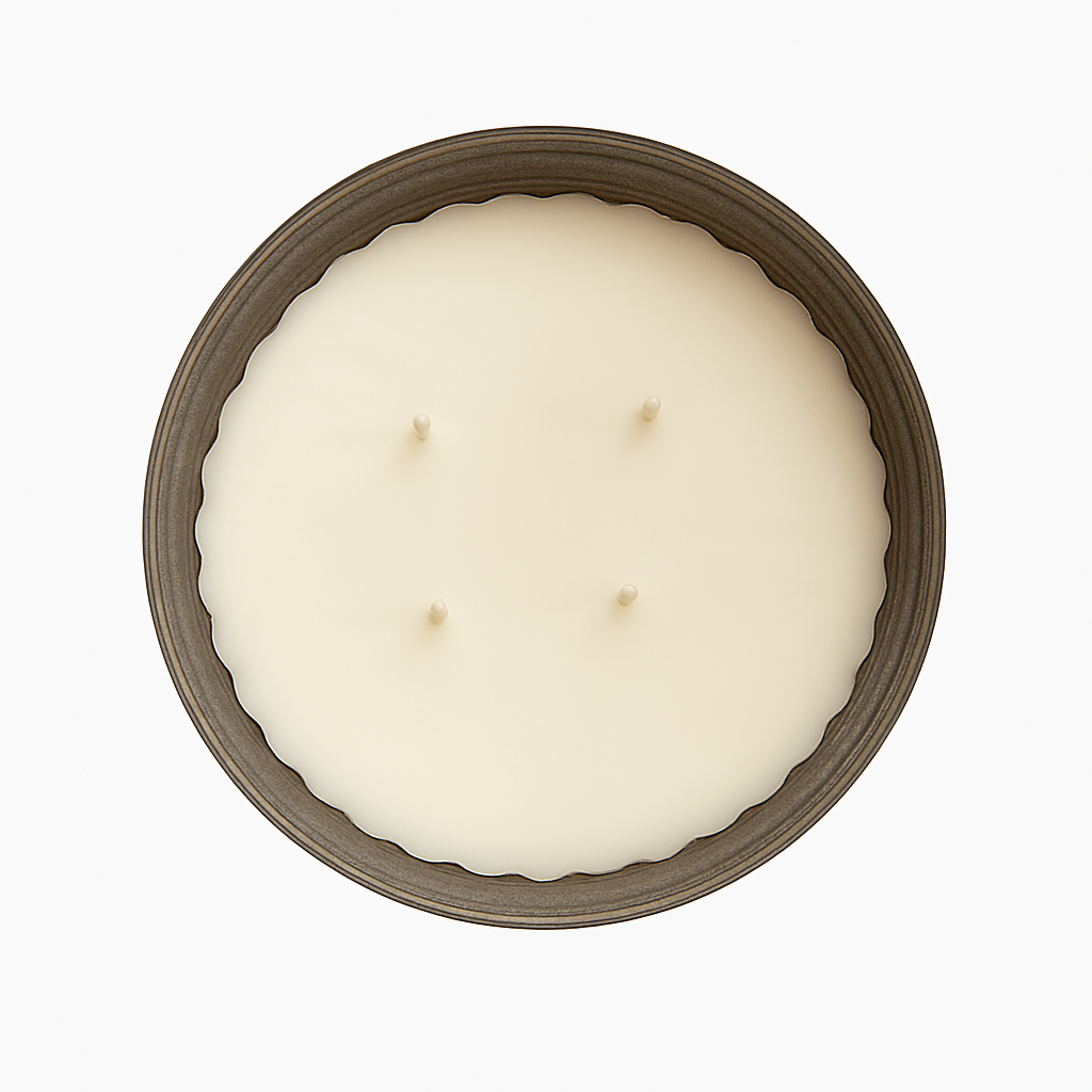Top-down view of a large four-wick soy wax candle in a rustic metal container with scalloped edges, set against a clean white background