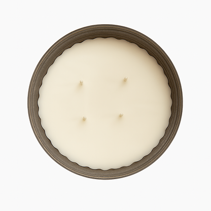 Top-down view of a large four-wick soy wax candle in a rustic metal container with scalloped edges, set against a clean white background