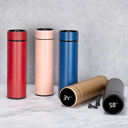 Set of colorful thermos bottles with digital temperature displays on a marble surface.